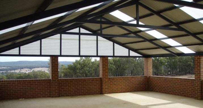 A spacious outdoor patio featuring a gable roof, creating a shaded and inviting space for relaxation and entertaining.